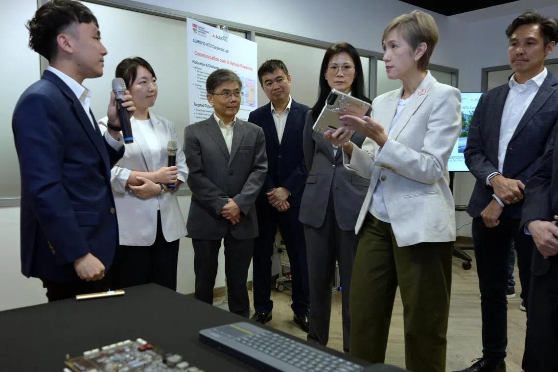 Minister for Digital Development and Information Josephine Teo with a Aumovio Automotive computer with local AI capability at the launch of phase two of the Aumovio-NTU Corporate Lab in April 6.