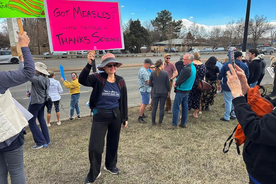 Protesters gather outside a National Oceanic and Atmospheric Administration building to decry the Trump administration's layoffs of workers on March 3.