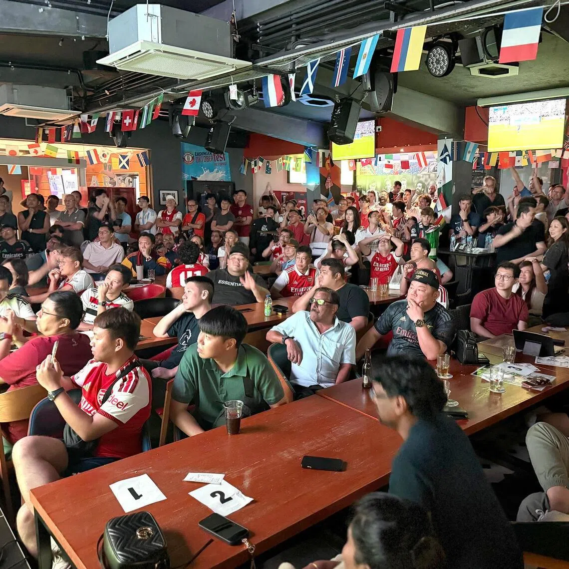 Fans watching a football match at ARFC Singapore in Woodleigh.