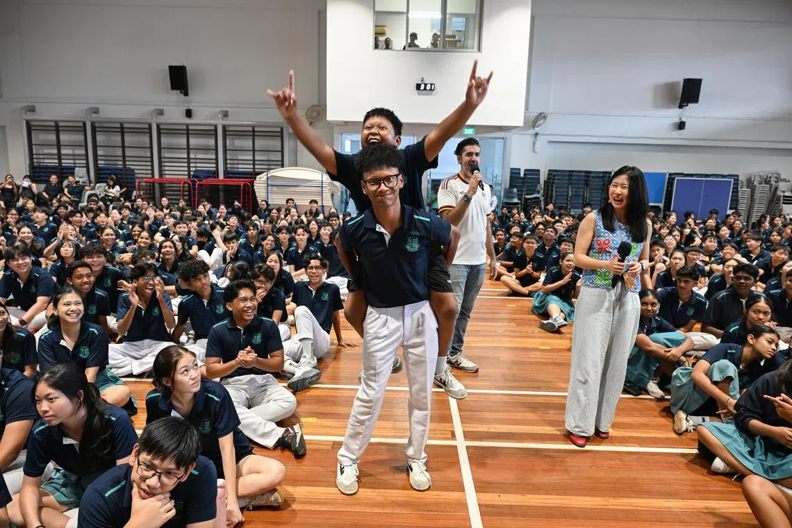 (From right) ST assistant Life editor Clara Lock and host Rishi Budhrani during the What’s the News? assembly programme at Swiss Cottage Secondary School on July 9.