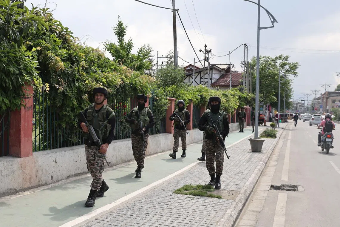 Indian paramilitary soldiers patrol a street in Srinagar, the summer capital of Indian Kashmir, on May 12.