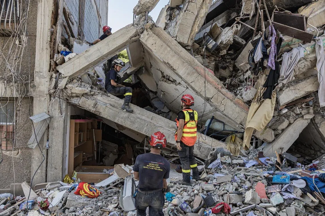 Members of the French rescue team conduct search operations in a building damaged by the earthquakes in Catia la Mar, Venezuela on June 29.