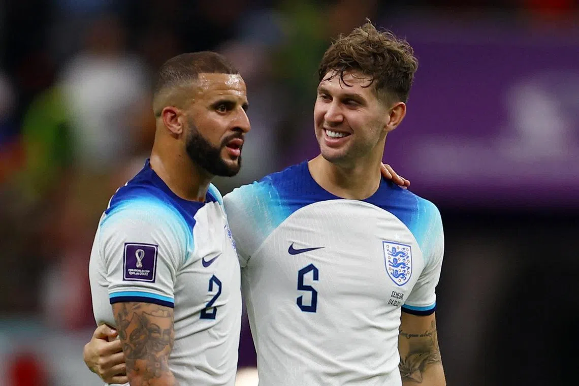 Soccer Football - FIFA World Cup Qatar 2022 - Round of 16 - England v Senegal - Al Bayt Stadium, Al Khor, Qatar - December 4, 2022
England's Kyle Walker and John Stones celebrate after the match as England progress to the quarter finals REUTERS/Molly Darlington