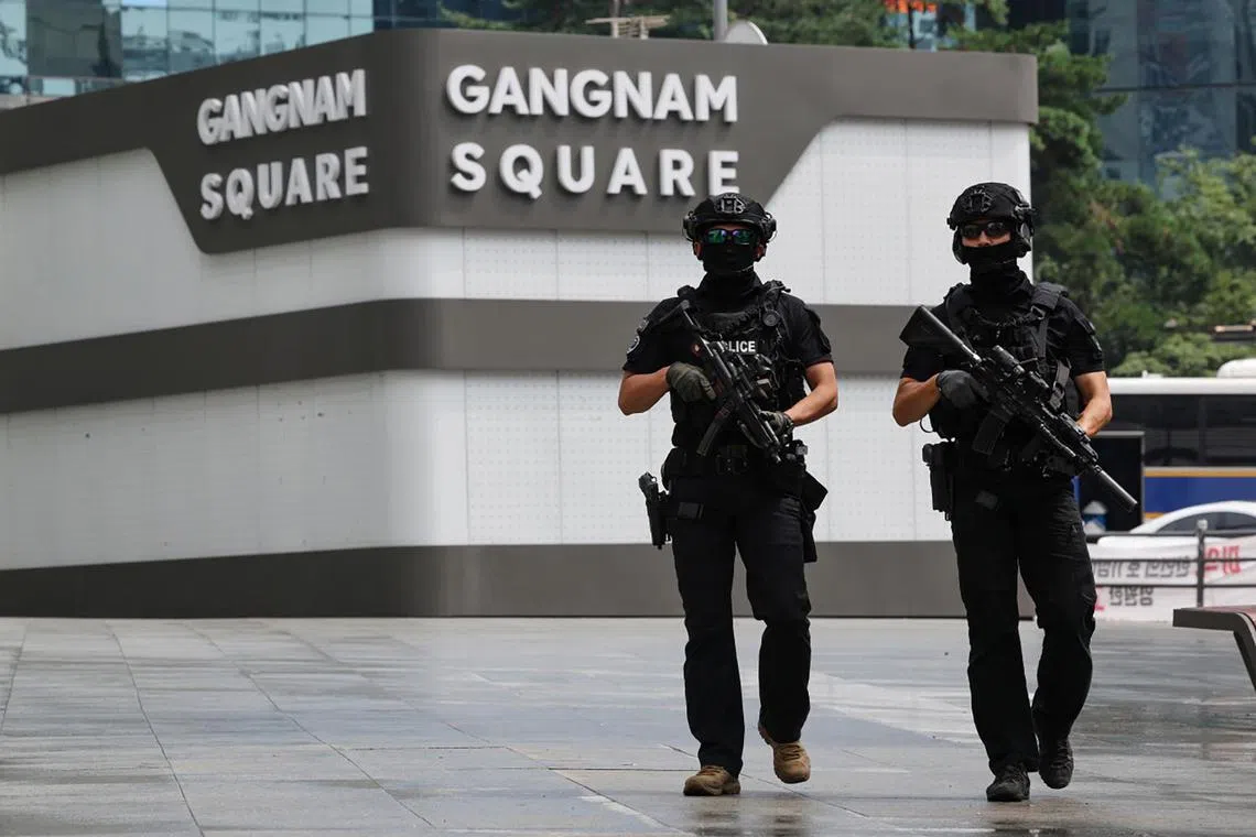 Police officers guard near the Gangnam station in southern Seoul on Aug 6, 2023.