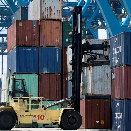 A forklift operator moving shipping containers at Port Everglades in Fort Lauderdale, Florida.