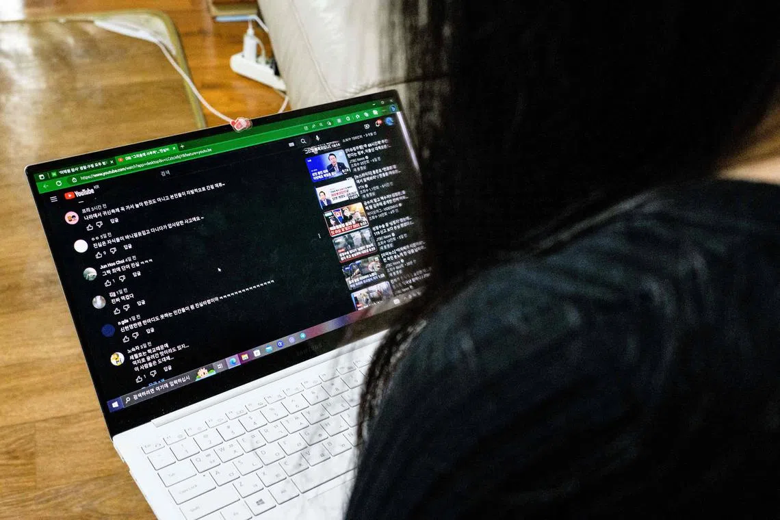 Ms Lee Ga-young, looking at online comments as she uses a laptop at their family home in Seoul on April 4.