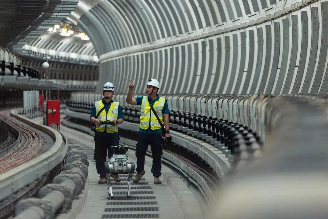 SP Group staff conducting an electricity cable tunnel inspection with the help of a robotic dog. 