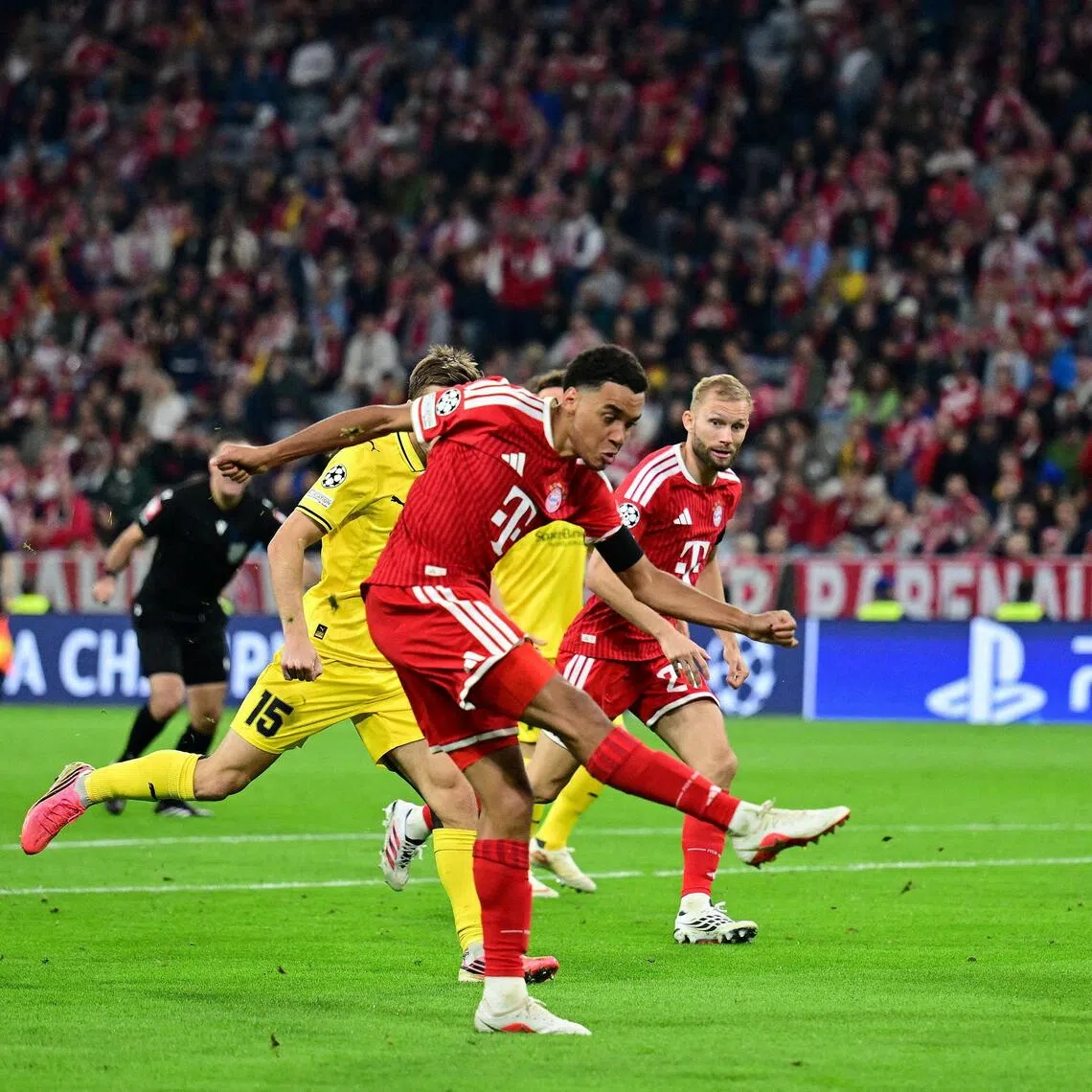Bayern Munich’s Jamal Musiala (left, in red) scores their first goal in the 5-0 win over Bodo-Glimt.