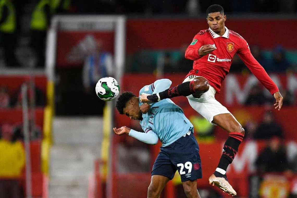Manchester United's English striker Marcus Rashford (R) fights for the ball with Burnley's Dutch defender Ian Maatsen during the English League Cup fourth round football match between Manchester United and Burnley, at Old Trafford, in Manchester, on December 21, 2022. (Photo by Oli SCARFF / AFP) / RESTRICTED TO EDITORIAL USE. No use with unauthorized audio, video, data, fixture lists, club/league logos or 'live' services. Online in-match use limited to 120 images. An additional 40 images may be used in extra time. No video emulation. Social media in-match use limited to 120 images. An additional 40 images may be used in extra time. No use in betting publications, games or single club/league/player publications. / 