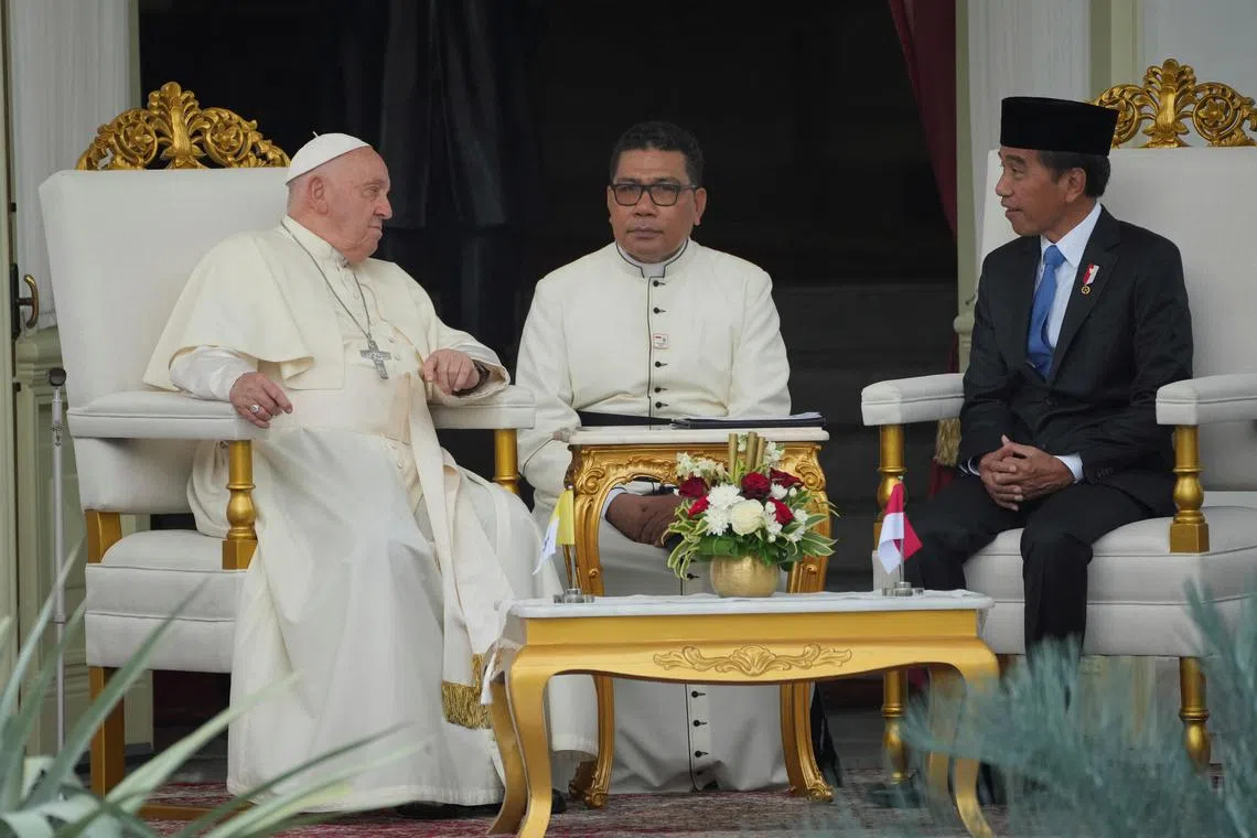 Pope Francis speaks with Indonesian President Joko Widodo (right) at the Presidential Palace in Jakarta, Indonesia, on Sept 4, 2024. 