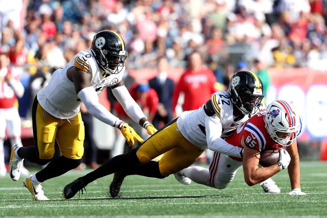 Juan Thornhill of the Pittsburgh Steelers tackles Hunter Henry of the New England Patriots in the fourth quarter of their NFL game at Gillette Stadium in Foxborough, Massachusetts on Sept 21, 2025.