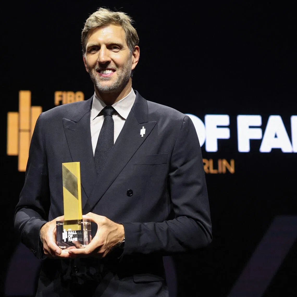 German former basketball player Dirk Nowitzki poses with his award at the International Basketball Federation FIBA Hall of Fame 2026 Induction ceremony in Berlin on April 21.