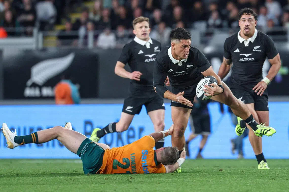 New Zealand's Quinn Tupaea is tackled by Australia's Ryan Lonergan during the Rugby Championship match.