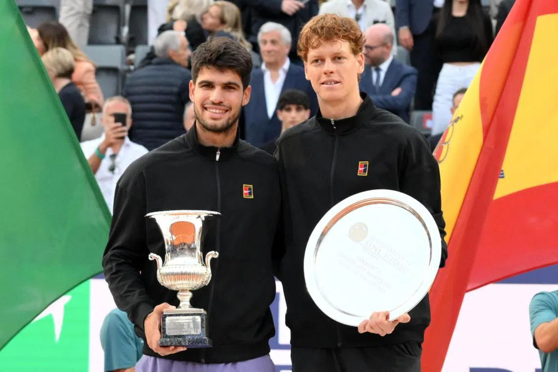 Carlos Alcaraz and Jannik Sinner pose for photos after their Italian Open final won by the former.