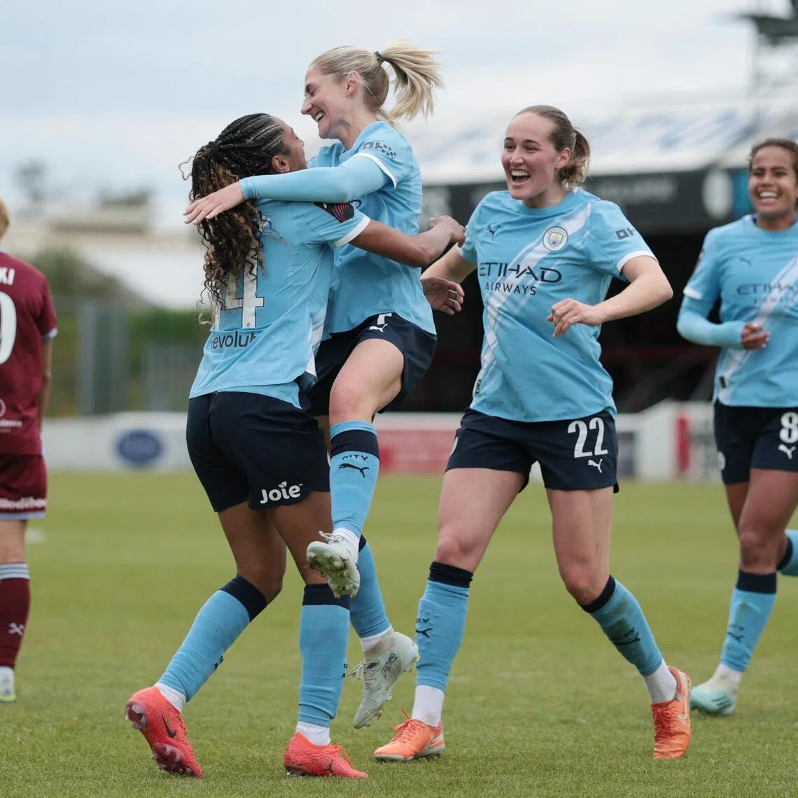 Manchester City's Laura Coombs celebrates scoring their fourth goal against West Ham United with teammates at the Chigwell Construction Stadium in London, on May 16, 2026.