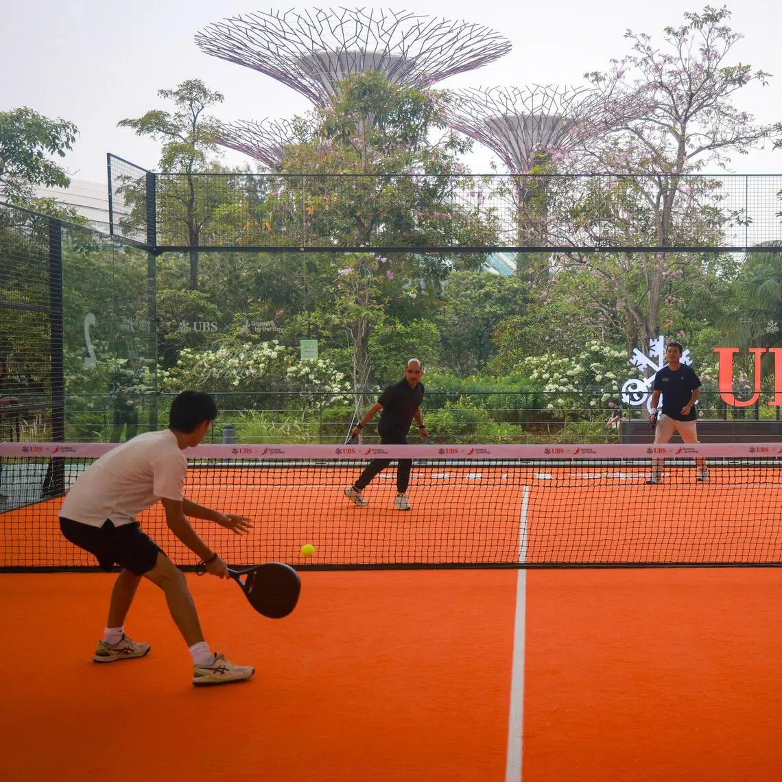 (From left) Community player Nate Wong, Senior Parliamentary Secretary Syed Harun Alhabsyi, national padel player Lim Han Ren and community player Celine Khoo having a game of padel at Gardens by the Bay on Sept 18.