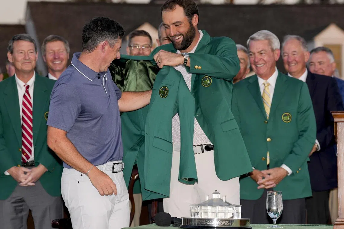 Apr 13, 2025; Augusta, Georgia, USA; Scottie Scheffler places the green jacket on Rory McIlroy during the green jacket ceremony during the final round of the Masters Tournament at Augusta National Golf Club. Mandatory Credit: Kyle Terada-Imagn Images