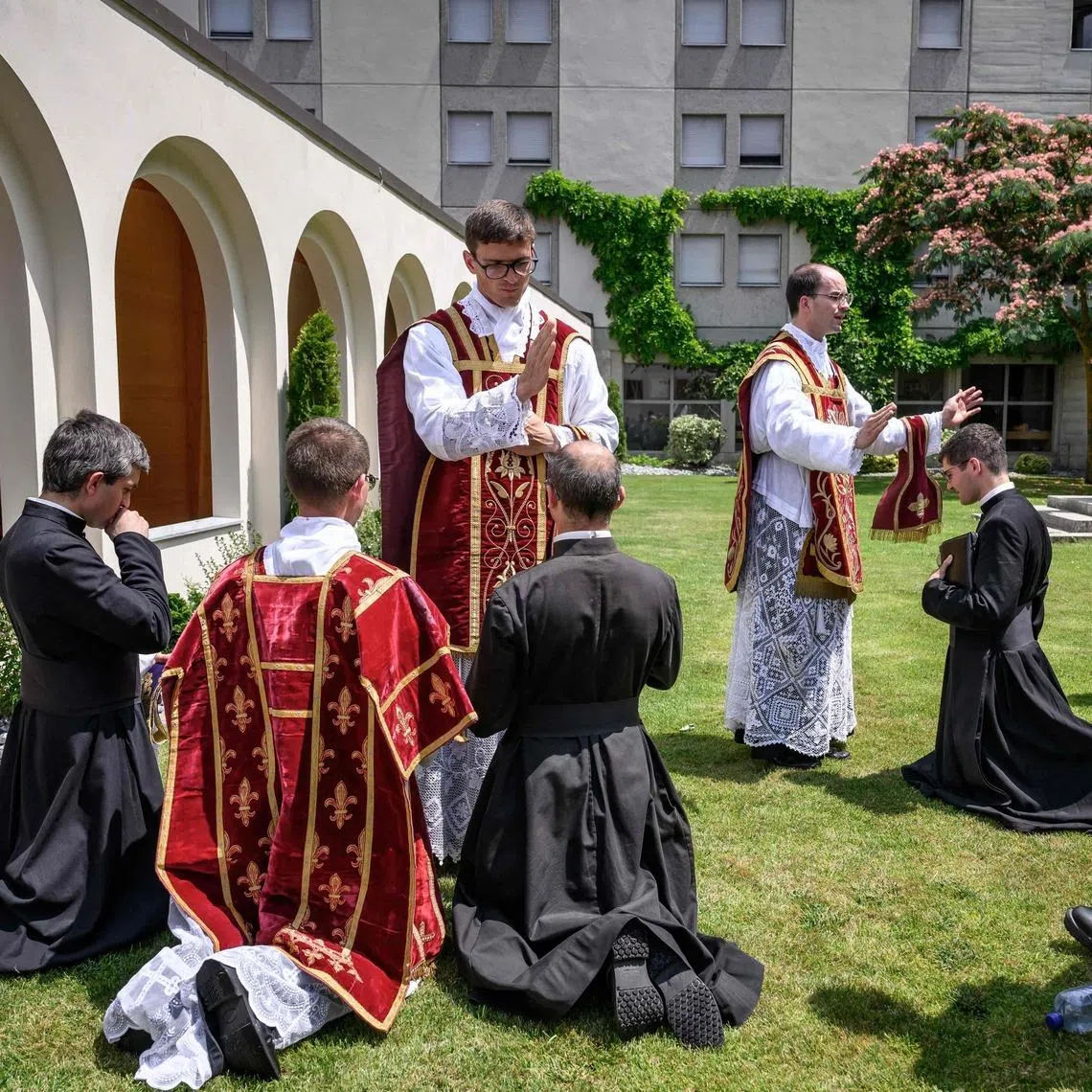 Priests receive blessings from newly ordained priests, after an ordination ceremony of the traditionalist Catholic Society of St Pius X, in Econe, near Sion, western Switzerland, on June 29. Defying Vatican, Society of St Pius X ordained its own bishops on July 1, 2026.