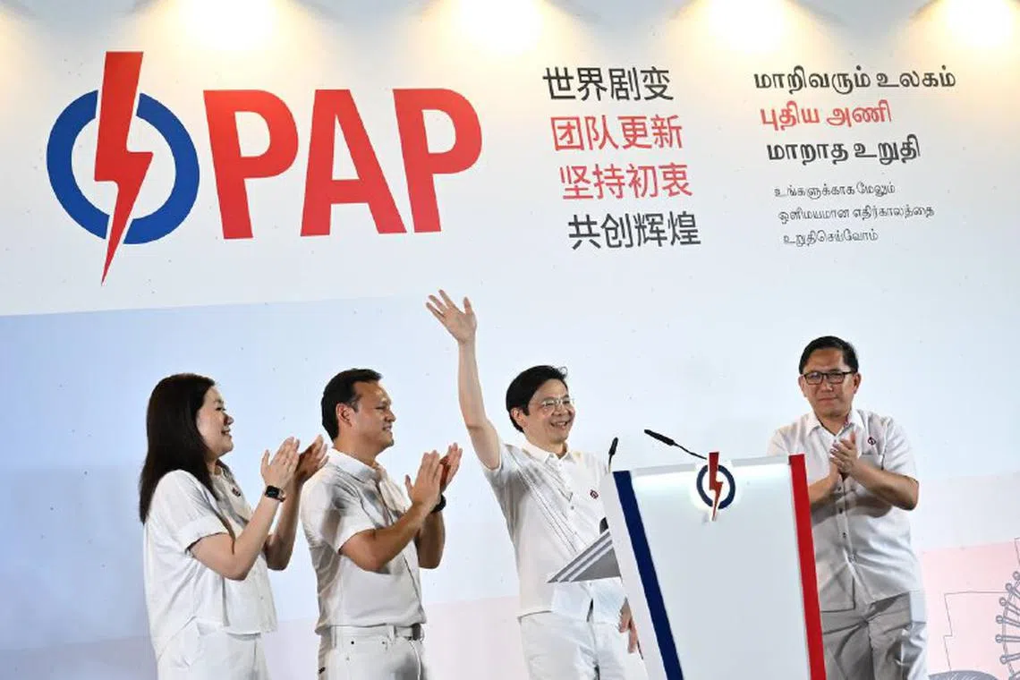 PAP's Marsiling-Yew Tee GRC candidates - (from left) Ms Hany Soh, Mr Zaqy Mohamad, Prime Minister Lawrence Wong and Mr Alex Yam thanking their supporters at Yio Chu Kang Stadium on May 3.