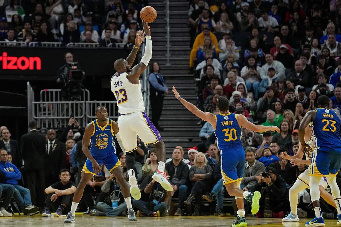 LeBron James of the Los Angeles Lakers shoots over Stephen Curry of the Golden State Warriors during the second half at Chase Centre.