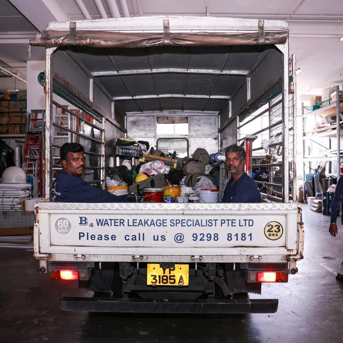 Workers aboard the lorry outside B4 Leakage Specialist in First Centre on March 20, 2026. ST PHOTO: BRIAN TEO