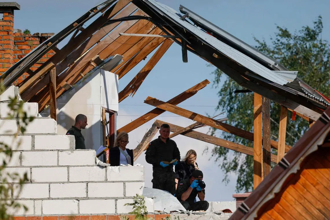 Police and army inspect damage to a house destroyed by debris from a shot down Russian drone in the village of Wyryki-Wola, eastern Poland, on September 10, 2025. NATO air defences helped counter drones that entered Polish airspace overnight and alliance chief Mark Rutte is in contact with Warsaw, a NATO spokeswoman said Wednesday. Polish Prime Minister Donald Tusk said Wednesday that a violation of Polish airspace by several Russian drones overnight was a major provocation aimed at the EU and NATO member. (Photo by Wojtek RADWANSKI / AFP)