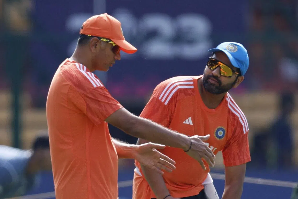India's captain Rohit Sharma with coach Rahul Dravid during practice, ahead of their Cricket World Cup semi-final against New Zealand.