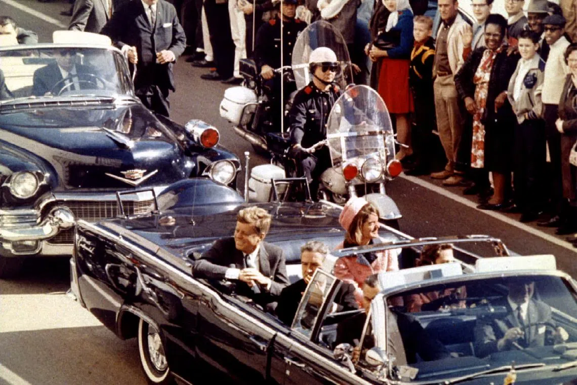 An archived photo shows former US President John F. Kennedy, first lady Jacqueline Kennedy and Texas Governor John Connally ride through Dallas moments before the president was assassinated on Nov 22, 1963.