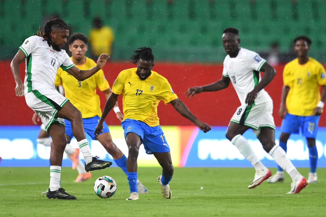 Soccer Football - FIFA World Cup - CAF Qualifiers - Playoffs - Semi Final - Nigeria v Gabon - Prince Moulay Hassan Stadium, Rabat, Morocco - November 13, 2025 Nigeria's Alex Iwobi in action with Gabon's Andre Poko REUTERS/Stringer