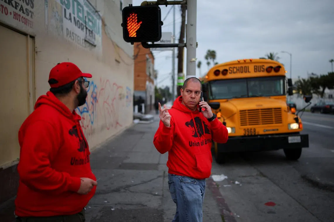 Ron Gochez, volunteer with immigrant rights advocacy group Union del Barrio, patrols for U.S. Immigration and Customs Enforcement activity in South Los Angeles, California, U.S. March 5, 2025. REUTERS/Daniel Cole