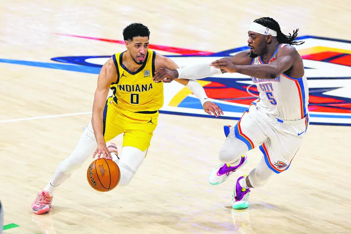 Indiana Pacers guard Tyrese Haliburton drives to the basket past Oklahoma City Thunder guard Luguentz Dort during Game 1 of the NBA Finals.