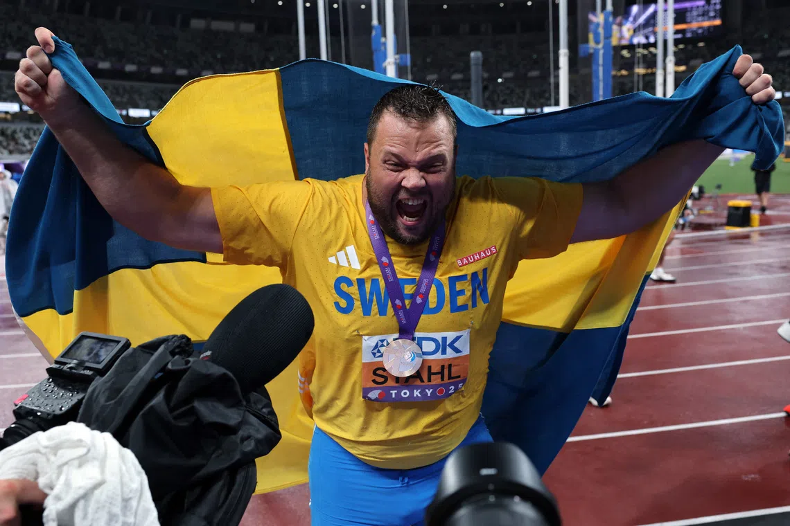 Sweden's Daniel Stahl celebrates with his medal and national flag after winning gold.