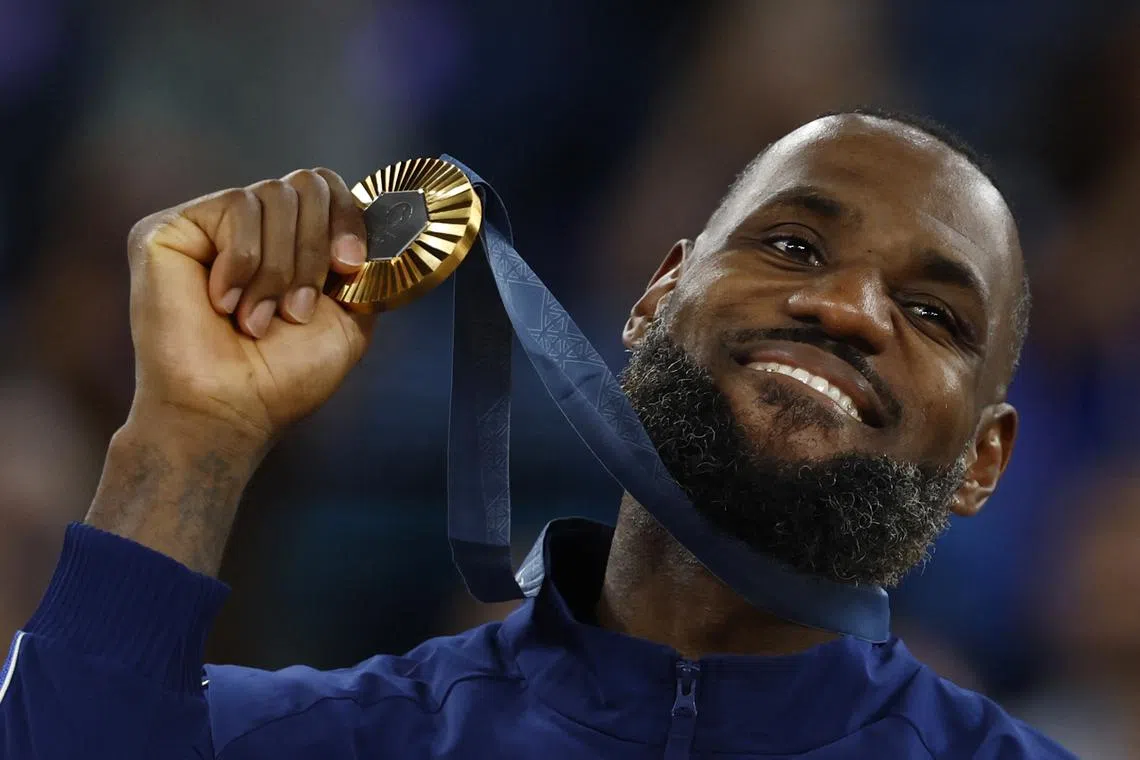 Paris 2024 Olympics - Basketball - Men's Victory Ceremony - Bercy Arena, Paris, France - August 10, 2024. Gold medallist Lebron James of United States poses with his medal. REUTERS/Evelyn Hockstein
