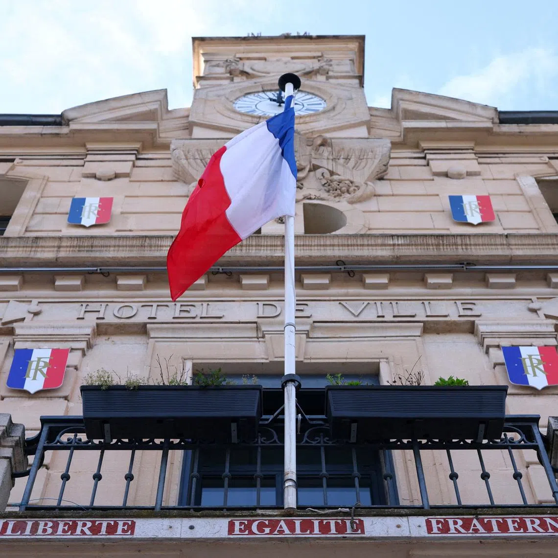 A French flag flies on the facade of the city hall of Gardanne ahead of upcoming mayoral election in France, March 4, 2026. REUTERS/Manon Cruz