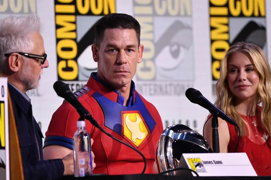 (From left) US director James Gunn, US actor John Cena and US actress Jennifer Holland attend the "Peacemaker" panel during Comic-Con International on July 26.