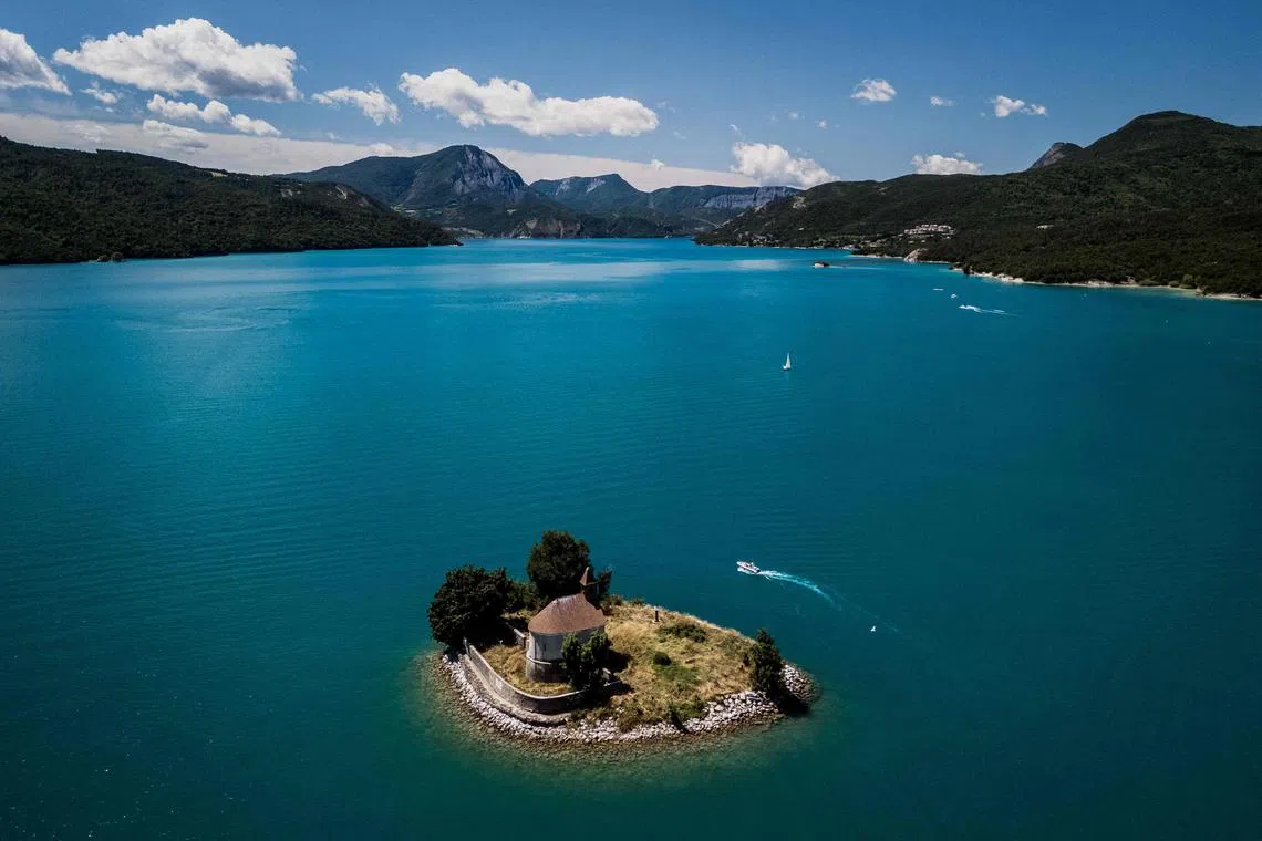 The Saint-Michel church on the lake of Serre-Poncon in Prunieres, southeastern France, on July 21, 2025.