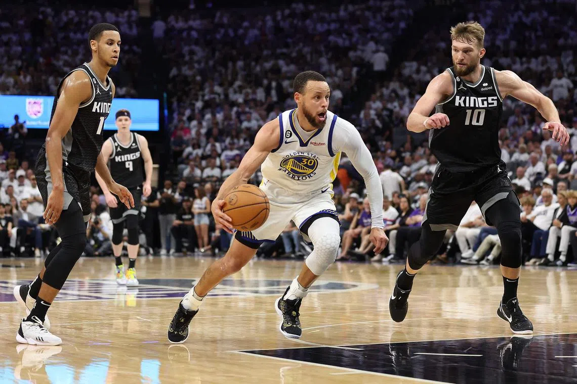 Stephen Curry of the Golden State Warriors dribbles against the Sacramento Kings during the fourth quarter of Game 7 of their NBA Western Conference first-round play-offs.
