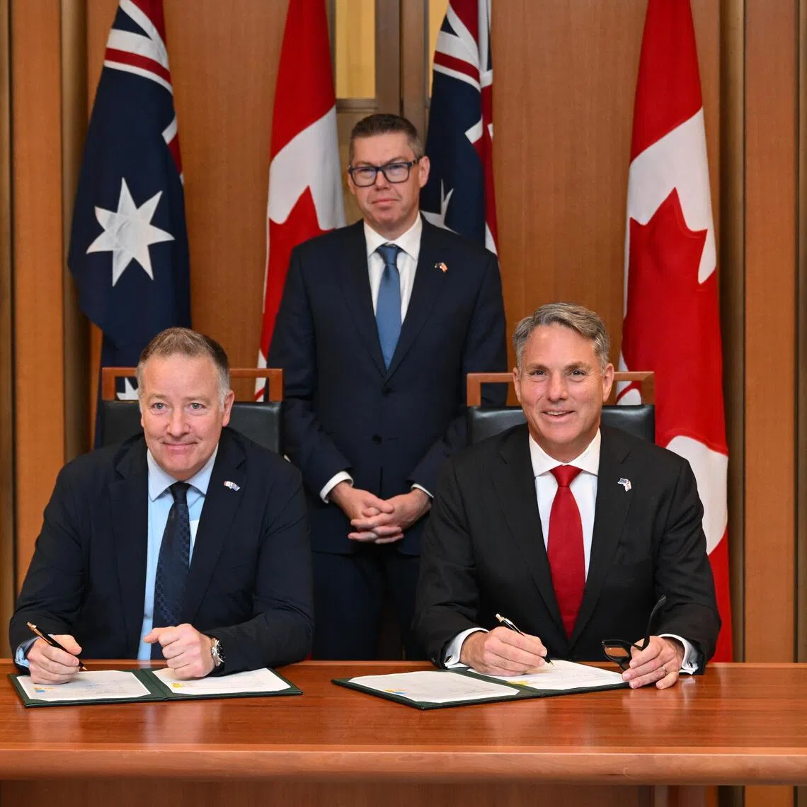 Australia's Defence Minister Richard Marles (right) and Canada’s Secretary of State for Defence Procurement Stephen Fuhr (left) sign a landmark government-to-government agreement on the export of an Australian Over-the-Horizon Radar (OTHR) system at Parliament House in Canberra, Australia on June 22, 2026.  