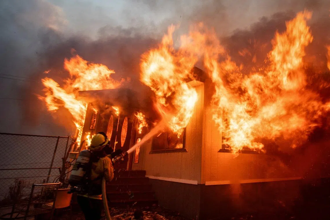 A firefighter battles the Palisades Fire as it burns on the west side of Los Angeles, California, on Jan 7.