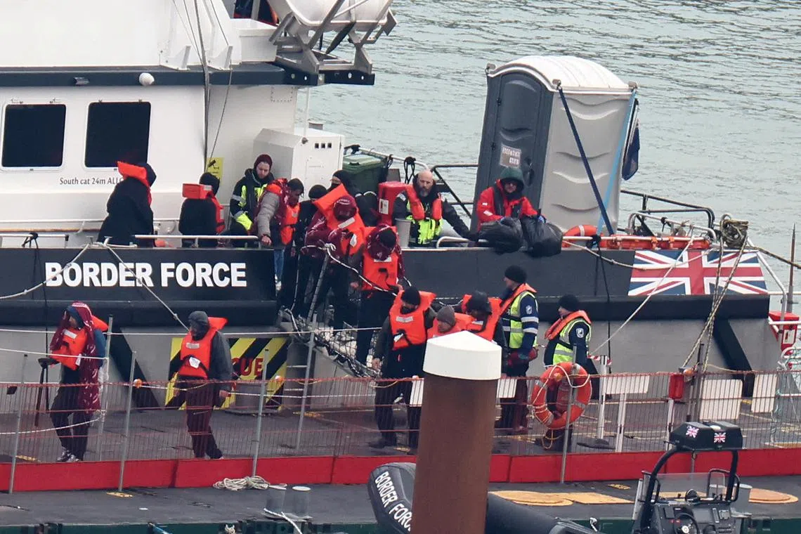 FILE PHOTO: People, believed to be migrants, disembark from a British Border Force vessel as they arrive at Port of Dover, Dover, Britain, January 17, 2024. REUTERS/Toby Melville/File Photo