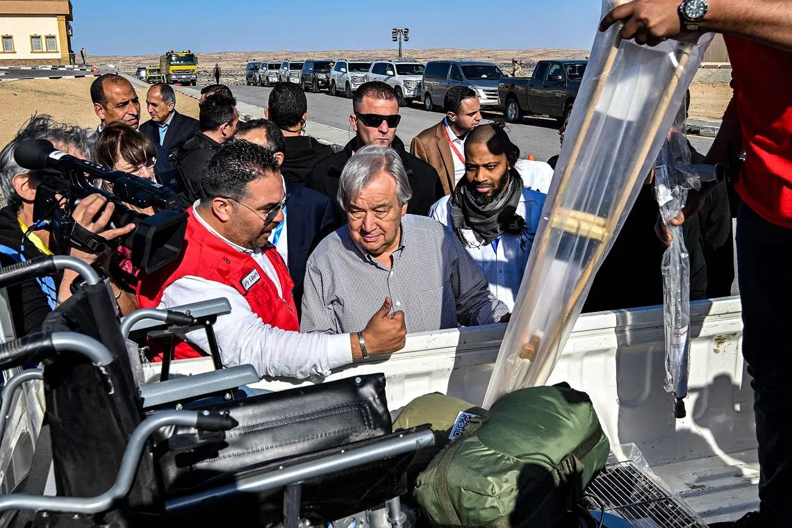 UN Secretary-General Antonio Guterres being briefed about items that were bound for the Gaza Strip but rejected by Israeli authorities, at El-Arish International Airport in Egypt on March 23.