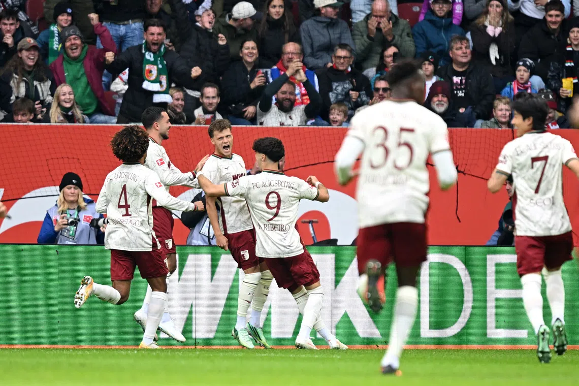 Soccer Football - Bundesliga - FC Augsburg v Bayern Munich - WWK Arena, Augsburg, Germany - October 10, 2026 FC Augsburg's Robin Fellhauer celebrates scoring their first goal with teammates REUTERS/Angelika Warmuth