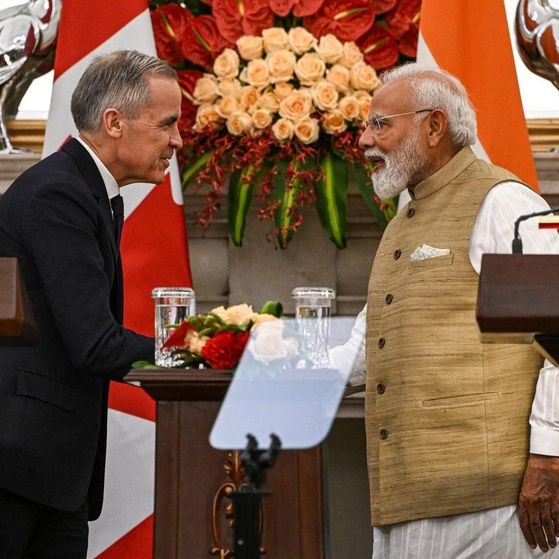 Narendra Modi, India's prime minister, right, shakes hands with Mark Carney, Canada's prime minister, during a news conference at Hyderabad House in New Delhi, India, on Monday, March 2, 2026. Carney met Modi in New Delhi on Monday to reset relations after years of strain, with both leaders looking to clinch deals to boost trade and supply chains. Photographer: Prakash Singh/Bloomberg