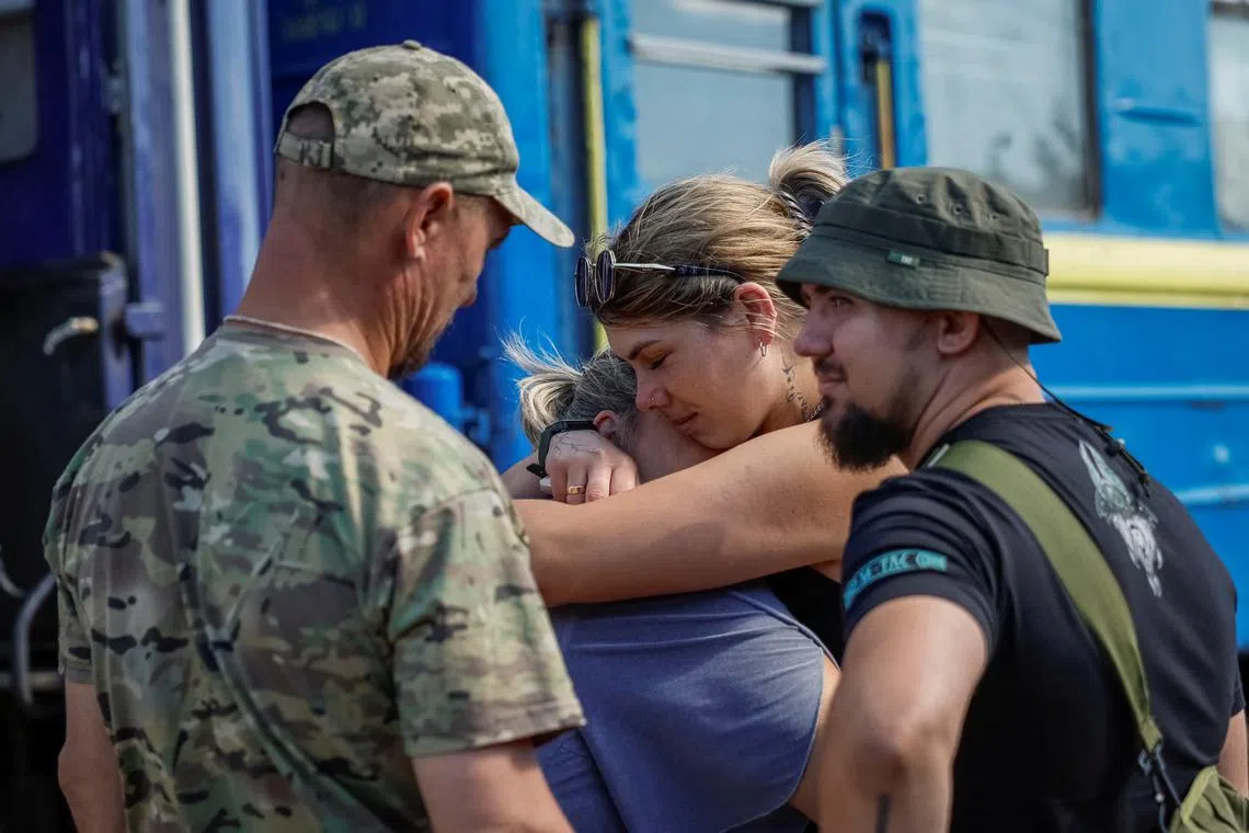 People hug each other as Ukrainian service members say bye to relatives who visited them, amid Russia’s attack on Ukraine, at the train station in Kramatorsk, Ukraine, June 21, 2024. REUTERS/Alina Smutko