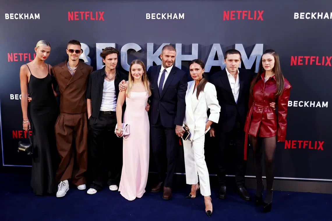 From left to right: Mia Regan, Romeo Beckham, Cruz Beckham, Harper Beckham, David Beckham, Victoria Beckham, Brooklyn Peltz Beckham, and Nicola Peltz Beckham attend the London premiere of Beckham on Oct 3.