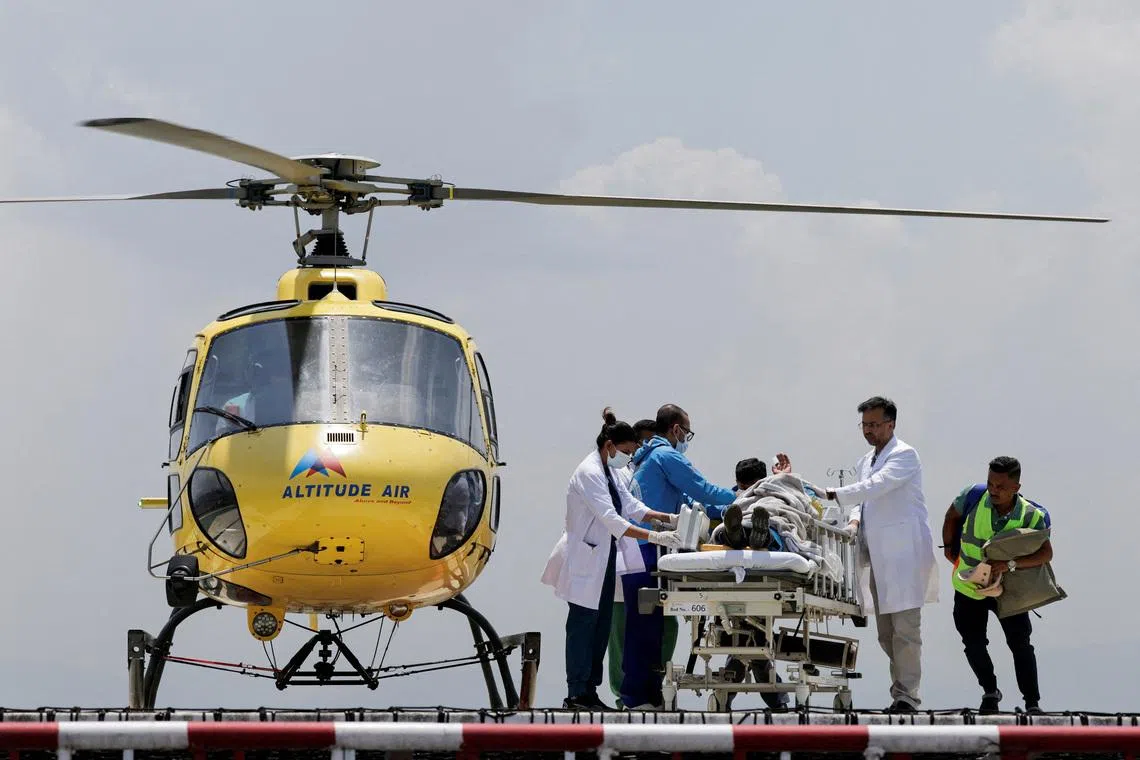 Paramedics work to transport Dawa Sherpa, who was missing for several days in the Everest region, from the helipad at HAMS Hospital in Kathmandu, Nepal, June 4, 2026. REUTERS/Navesh Chitrakar
