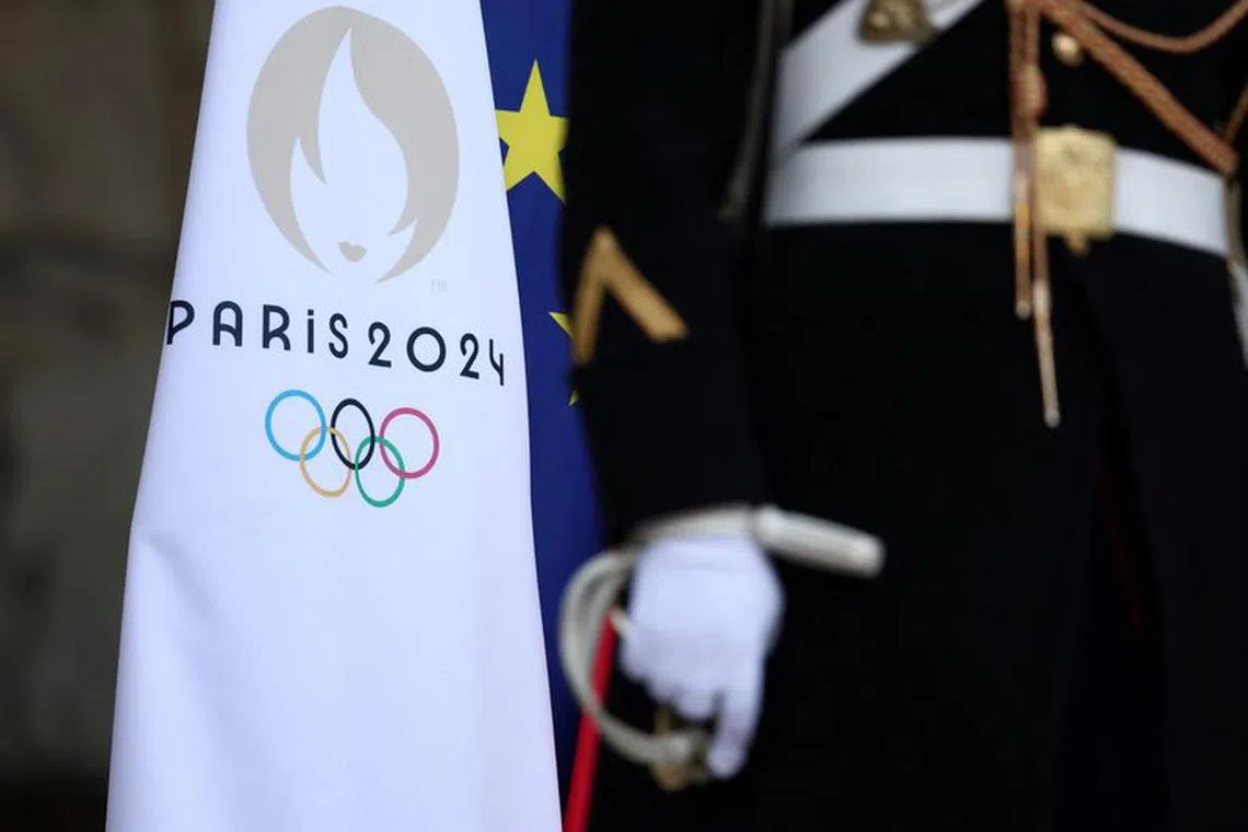 FILE PHOTO: A French Republican Guard stands next to the flag of the Paris 2024 Olympic Games at the entrance of the Elysee Palace in Paris, France, January 24, 2024. REUTERS/Stephanie Lecocq/File Photo