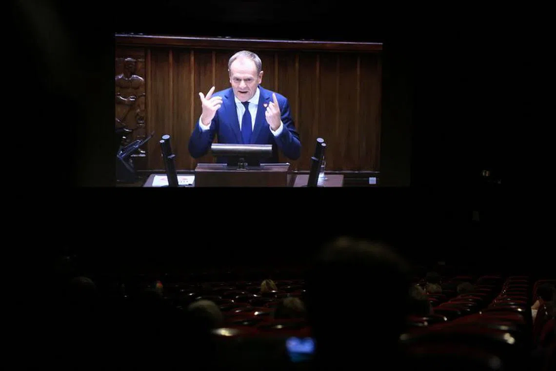 Newly appointed Polish Prime Minister Donald Tusk presenting his government's programme in Parliament is displayed on the screen at the cinema in Warsaw, Poland December 12, 2023. Maciej Jazwiecki/Agencja Wyborcza.pl via REUTERS