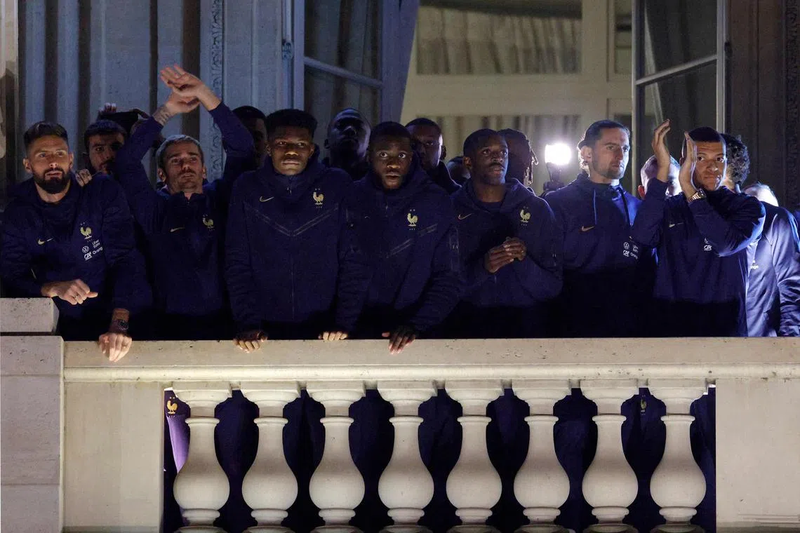 French national football team players greeting supporters at the Hotel de Crillon in Paris, a day after their Qatar 2022 World Cup final defeat by Argentina.
