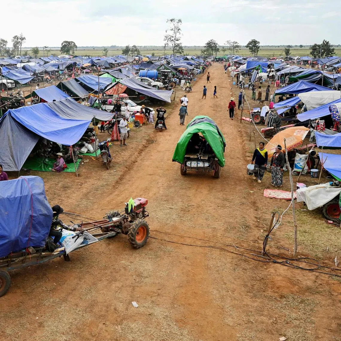 Displaced people arrive at a temporary camp in Cambodia's Oddar Meanchey province on December 11, 2025, amid clashes along the Cambodia-Thailand border. Renewed fighting raged at the border of Cambodia and Thailand on December 11, with combat heard near centuries-old temples, ahead of an expected phone call from US President Donald Trump to the two nations' leaders. (Photo by TANG CHHIN Sothy / AFP)